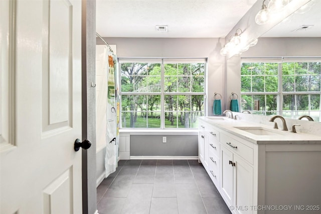 21304 S 4200th Rd, Claremore, OK 74019 - full bath with double vanity, tile patterned floors, and plenty of natural light
