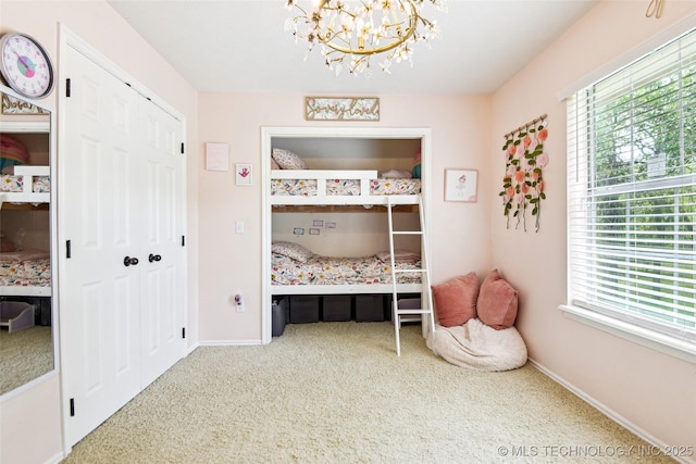 21304 S 4200th Rd, Claremore, OK 74019 - bedroom featuring carpet flooring, a chandelier, baseboards, and a closet