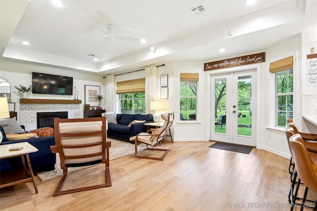 21304 S 4200th Rd, Claremore, OK 74019 - living room featuring crown molding, a raised ceiling, wood finished floors, plenty of natural light, and french doors