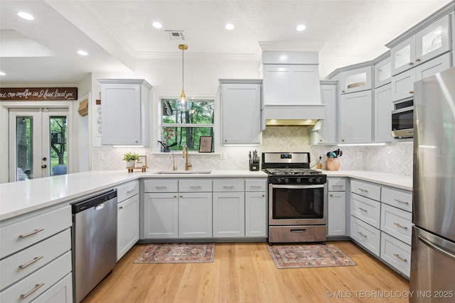 21304 S 4200th Rd, Claremore, OK 74019 - kitchen featuring appliances with stainless steel finishes, a sink, premium range hood, light countertops, and light wood finished floors
