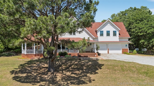 5094 N 209th W Ave, Sand Springs, OK 74063 - view of front facade featuring gravel driveway, a garage, a porch, a front lawn, and brick siding