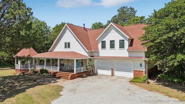 5094 N 209th W Ave, Sand Springs, OK 74063 - view of front facade featuring a porch, driveway, a garage, and brick siding