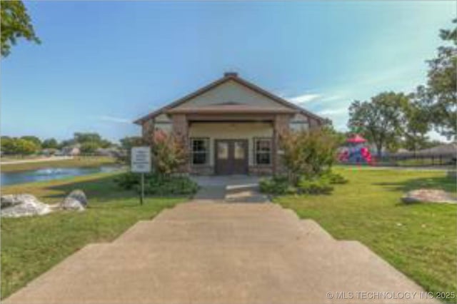 2805 W Fredericksburg St, Broken Arrow, OK 74011 - view of front of home featuring french doors, a water view, and a front lawn