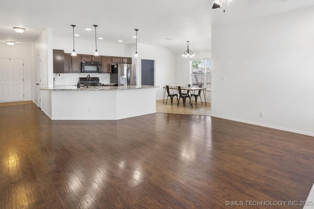 2805 W Fredericksburg St, Broken Arrow, OK 74011 - kitchen with stainless steel fridge with ice dispenser, black microwave, dark wood-type flooring, backsplash, and dark brown cabinets