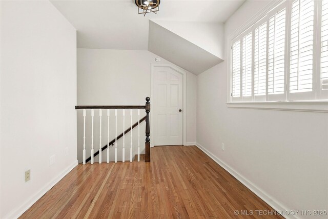 1208 E 29th St, Tulsa, OK 74114 - additional living space featuring wood finished floors, baseboards, and vaulted ceiling