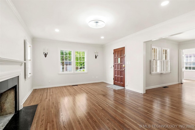 1208 E 29th St, Tulsa, OK 74114 - unfurnished living room featuring healthy amount of natural light, a fireplace with flush hearth, wood finished floors, baseboards, and ornamental molding