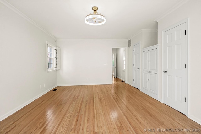 1208 E 29th St, Tulsa, OK 74114 - spare room featuring crown molding, light wood-type flooring, and baseboards