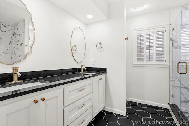 1208 E 29th St, Tulsa, OK 74114 - bathroom with a marble finish shower, double vanity, tile patterned flooring, and baseboards