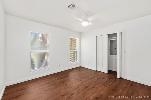 6345 W 53rd St, Tulsa, OK 74126 - unfurnished bedroom with dark wood finished floors, baseboards, a ceiling fan, and a closet