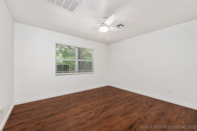 6345 W 53rd St, Tulsa, OK 74126 - spare room with dark wood-style flooring and baseboards