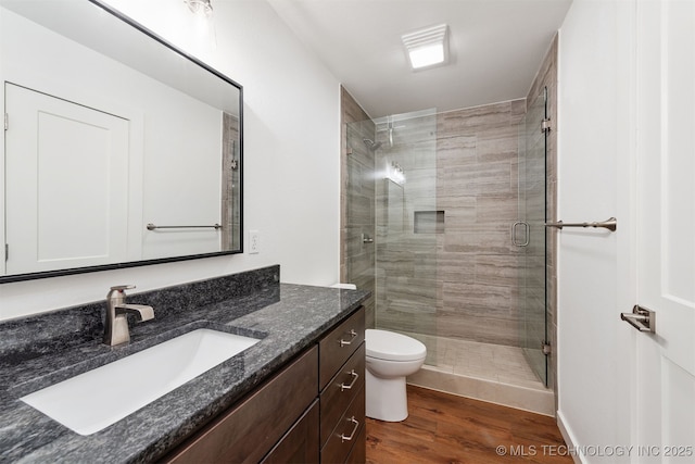 6345 W 53rd St, Tulsa, OK 74126 - bathroom with a stall shower, wood finished floors, vanity, and toilet