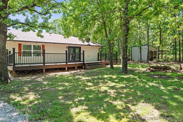 6345 W 53rd St, Tulsa, OK 74126 - view of green lawn with a storage shed, a wooden deck, an outbuilding, and french doors