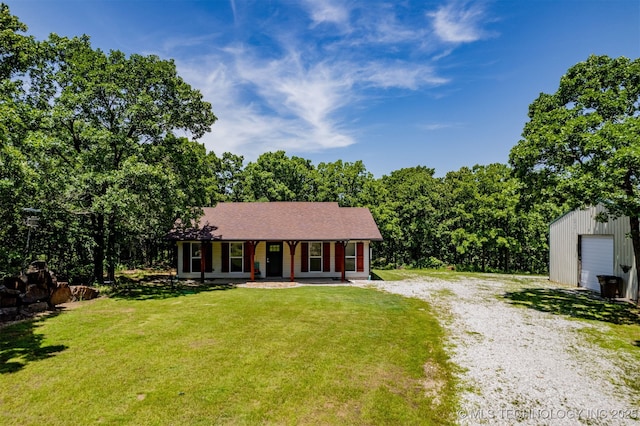 6345 W 53rd St, Tulsa, OK 74126 - ranch-style house with a porch, a front lawn, driveway, and an outbuilding