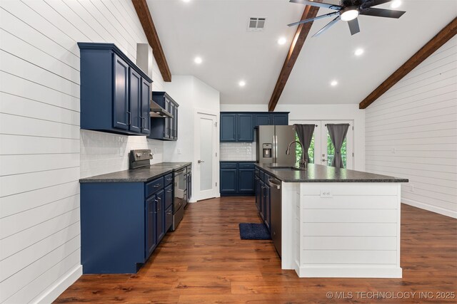 6345 W 53rd St, Tulsa, OK 74126 - kitchen with appliances with stainless steel finishes, blue cabinetry, dark countertops, a ceiling fan, and wooden walls