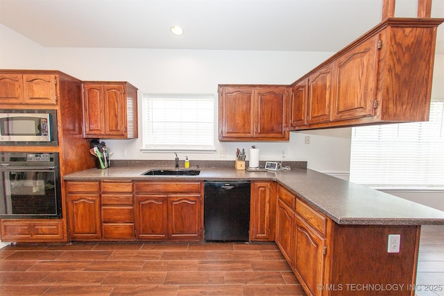 kitchen featuring black appliances, a sink, a peninsula, dark countertops, and recessed lighting