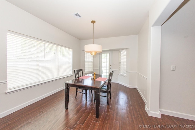 dining area featuring dark wood-style floors and baseboards