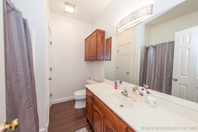 full bath with wood finished floors, baseboards, vanity, and toilet