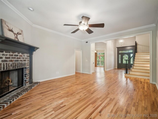 506 E 120th Pl S, Jenks, OK 74037 - unfurnished living room featuring a fireplace, a ceiling fan, light wood finished floors, ornamental molding, and stairs