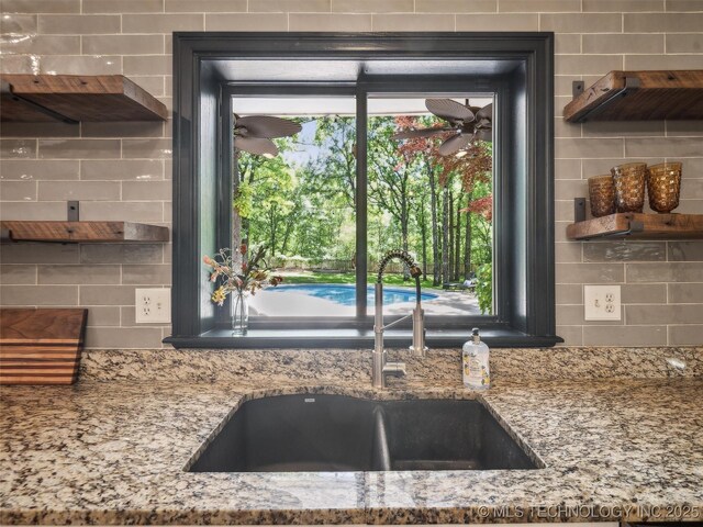 506 E 120th Pl S, Jenks, OK 74037 - kitchen featuring a sink, tasteful backsplash, and light stone countertops