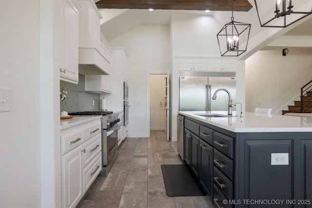 16958 E 45th St, Tulsa, OK 74134 - kitchen featuring built in appliances, white cabinets, high vaulted ceiling, tasteful backsplash, and a chandelier