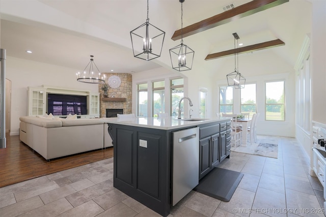 16958 E 45th St, Tulsa, OK 74134 - kitchen featuring stainless steel dishwasher, a chandelier, a stone fireplace, light countertops, and plenty of natural light