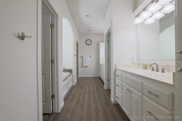 16958 E 45th St, Tulsa, OK 74134 - bathroom with two vanities, wood finished floors, and a garden tub