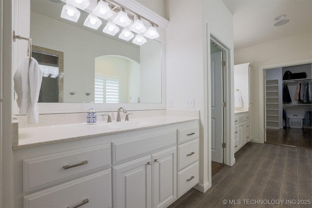 16958 E 45th St, Tulsa, OK 74134 - bathroom with vanity, wood finished floors, and a walk in closet