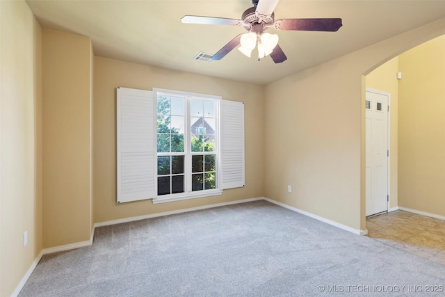 2000 W Vail St, Broken Arrow, OK 74012 - carpeted spare room with arched walkways, ceiling fan, and baseboards