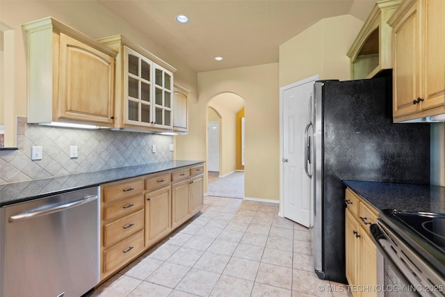 2000 W Vail St, Broken Arrow, OK 74012 - kitchen featuring stainless steel dishwasher, arched walkways, backsplash, glass insert cabinets, and recessed lighting