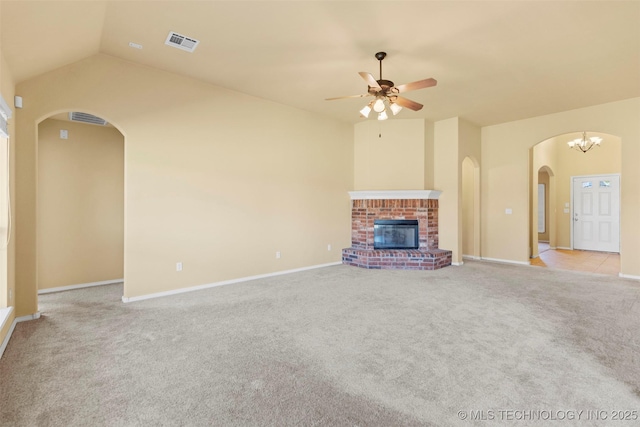2000 W Vail St, Broken Arrow, OK 74012 - unfurnished living room featuring arched walkways, light colored carpet, a ceiling fan, vaulted ceiling, and a brick fireplace