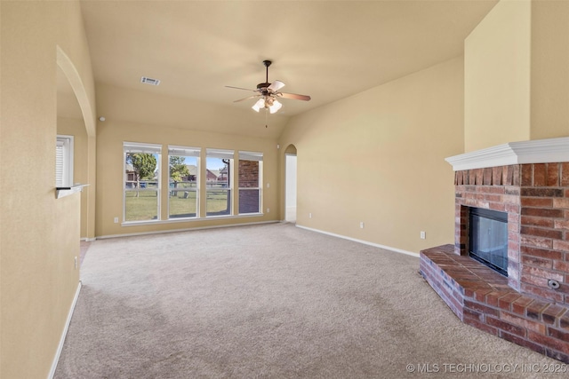 2000 W Vail St, Broken Arrow, OK 74012 - unfurnished living room featuring arched walkways, carpet flooring, a ceiling fan, a fireplace, and lofted ceiling