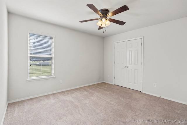 2000 W Vail St, Broken Arrow, OK 74012 - unfurnished bedroom featuring carpet flooring, a closet, baseboards, and a ceiling fan