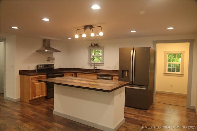 1185 E Pine St, Westville, OK 74965 - kitchen featuring appliances with stainless steel finishes, wall chimney exhaust hood, a sink, butcher block counters, and recessed lighting