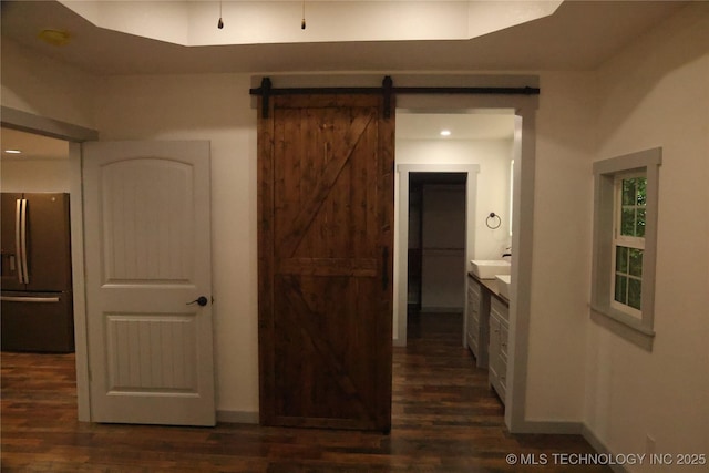 1185 E Pine St, Westville, OK 74965 - hallway with dark wood-style flooring, a barn door, baseboards, and recessed lighting