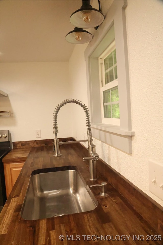 1185 E Pine St, Westville, OK 74965 - kitchen view of a sink, dark countertops, and electric range oven
