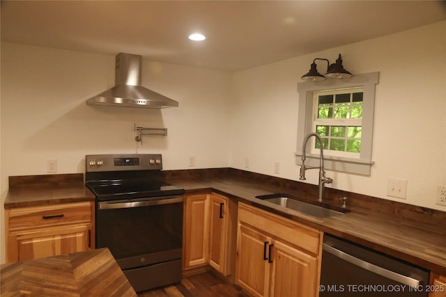 1185 E Pine St, Westville, OK 74965 - kitchen featuring appliances with stainless steel finishes, wall chimney exhaust hood, a sink, butcher block countertops, and dark wood-style floors