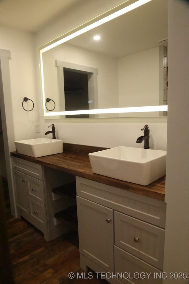 1185 E Pine St, Westville, OK 74965 - bathroom featuring double vanity, wood finished floors, and recessed lighting