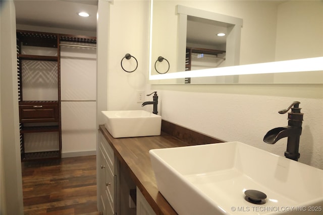 1185 E Pine St, Westville, OK 74965 - bathroom featuring wood finished floors, double vanity, and recessed lighting