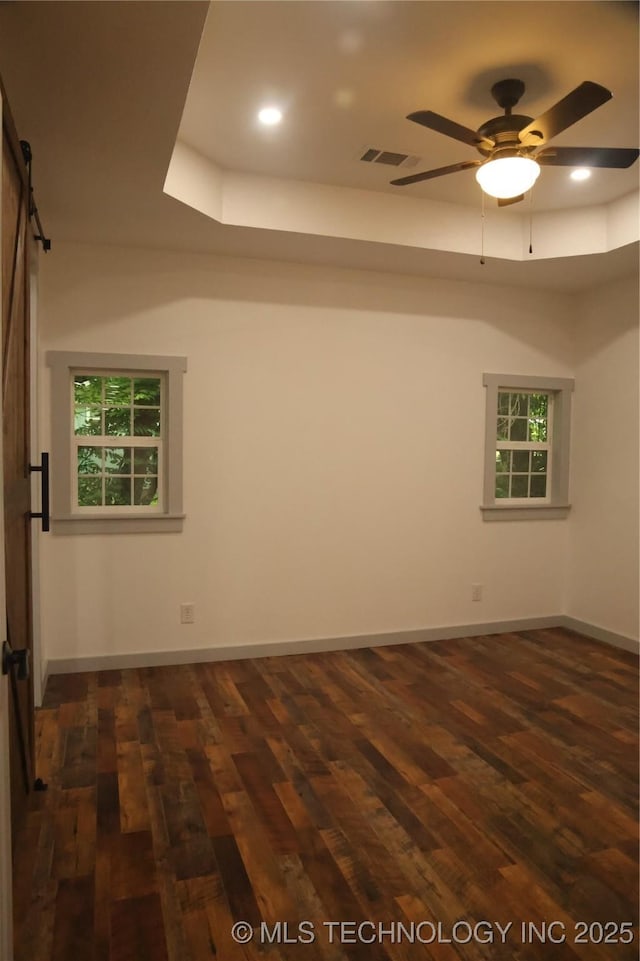 1185 E Pine St, Westville, OK 74965 - empty room featuring dark wood finished floors, a barn door, ceiling fan, baseboards, and recessed lighting