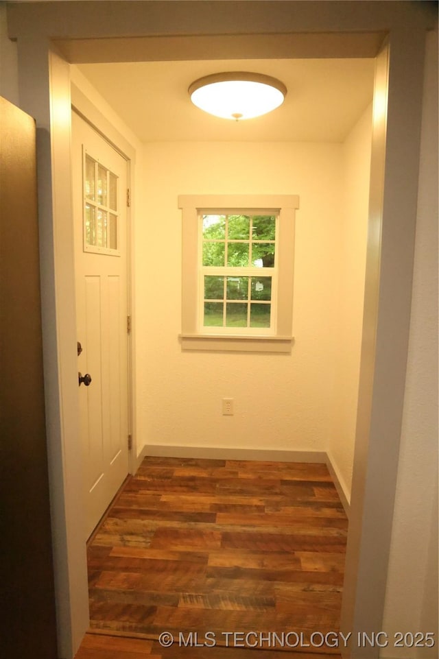 1185 E Pine St, Westville, OK 74965 - hallway featuring dark wood-style floors and baseboards