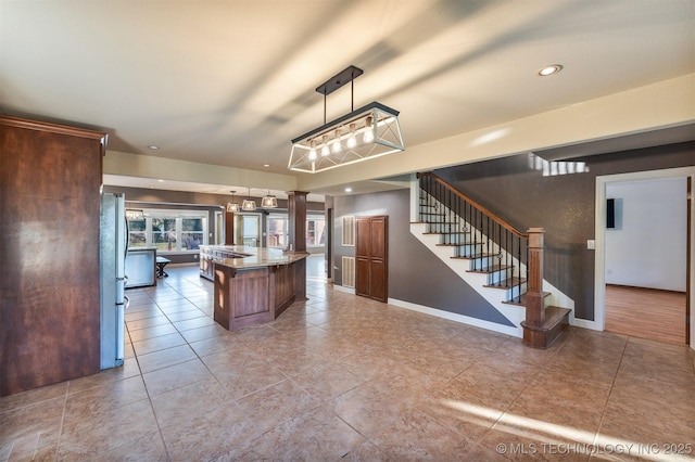 5378 W 450th Rd, Pryor, OK 74361 - kitchen with a kitchen island, freestanding refrigerator, tile patterned flooring, baseboards, and pendant lighting