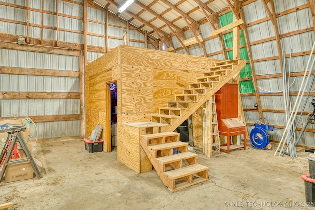 5378 W 450th Rd, Pryor, OK 74361 - staircase featuring metal wall, vaulted ceiling, and unfinished concrete floors