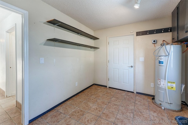 5378 W 450th Rd, Pryor, OK 74361 - basement featuring electric water heater, a textured ceiling, and light tile patterned floors