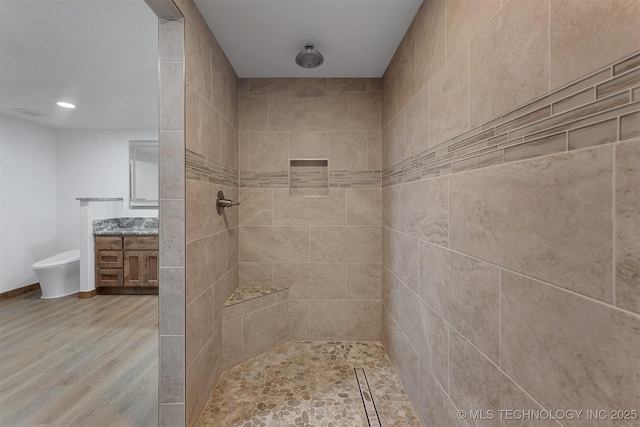 5378 W 450th Rd, Pryor, OK 74361 - bathroom with tiled shower, vanity, and wood finished floors