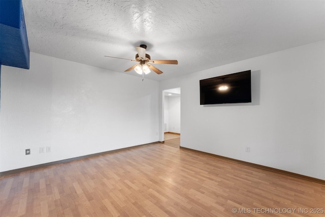 5378 W 450th Rd, Pryor, OK 74361 - unfurnished living room with a ceiling fan, baseboards, wood finished floors, and a textured ceiling