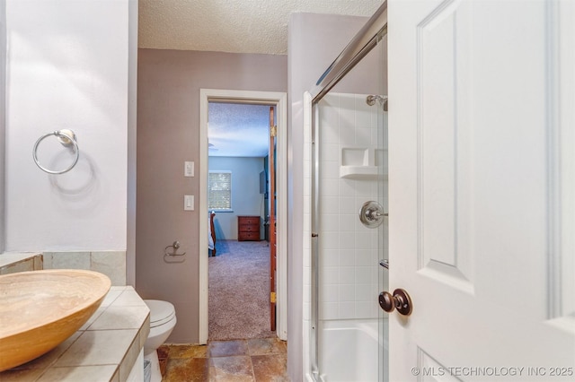 5378 W 450th Rd, Pryor, OK 74361 - full bath featuring a textured ceiling, an enclosed shower, toilet, and vanity