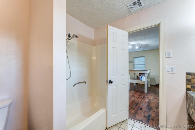 5378 W 450th Rd, Pryor, OK 74361 - full bath with a textured ceiling, toilet, tile patterned flooring, and shower / bath combination