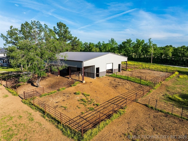 5378 W 450th Rd, Pryor, OK 74361 - rear view of property with an exterior structure, driveway, a detached garage, an outdoor structure, and metal roof
