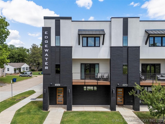 3741 Riverside Dr Unit 3741, Tulsa, OK 74105 - view of front of home featuring a standing seam roof, stucco siding, and metal roof