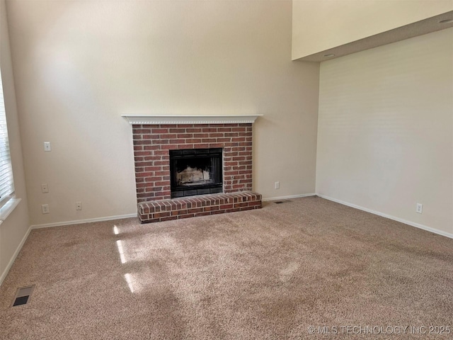7333 W 36th St, Tulsa, OK 74107 - unfurnished living room with carpet floors, a brick fireplace, and baseboards